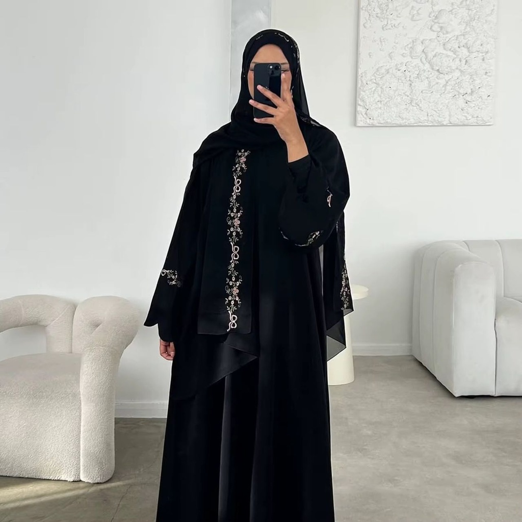 ABAYA Flowy embroidered sleeves with floral vine detailing.